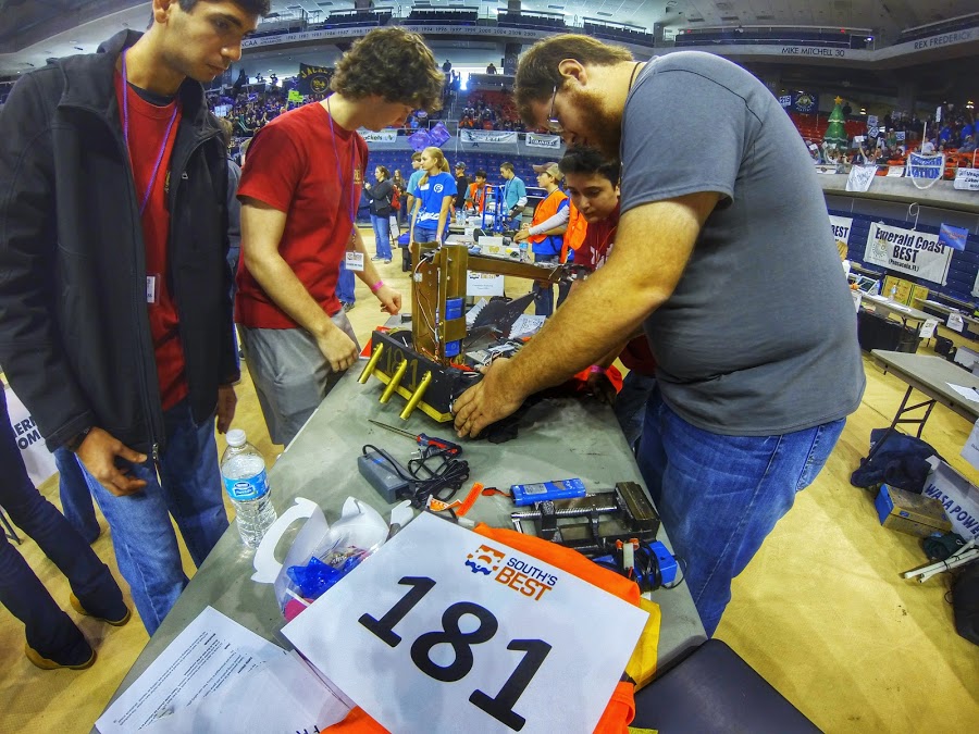 A group of teammates making changes to their robot at the South's BEST Robotics Championships.
